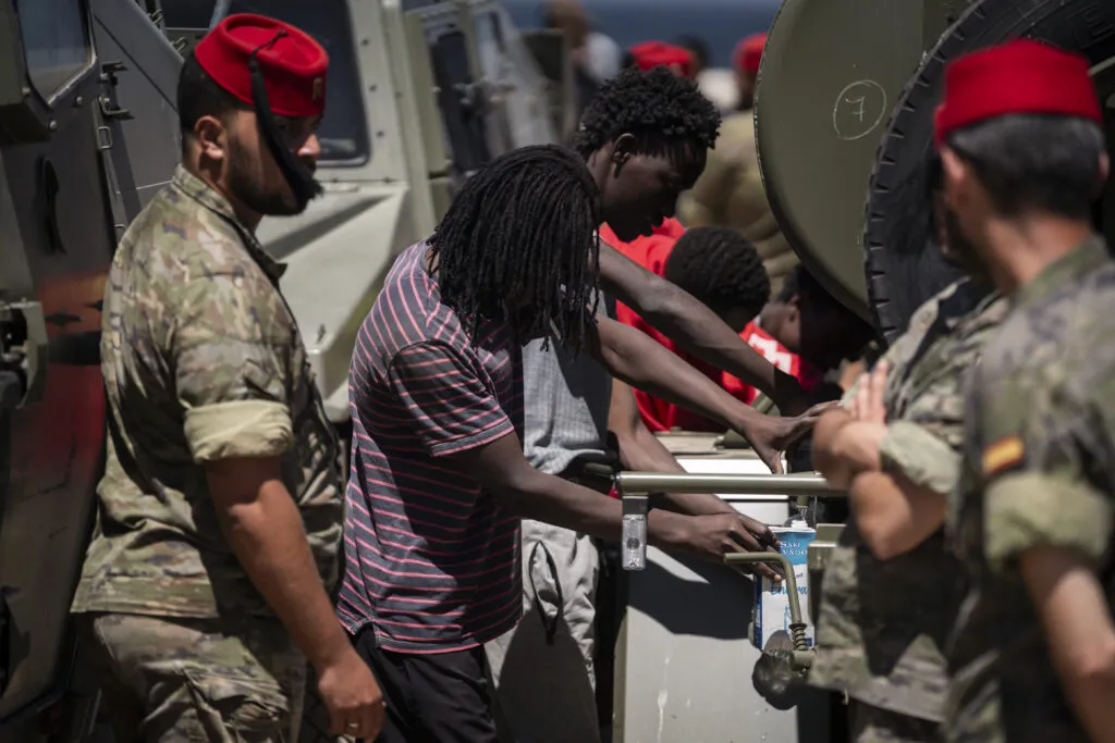 Migrants receiving aid on a Ceuta beach